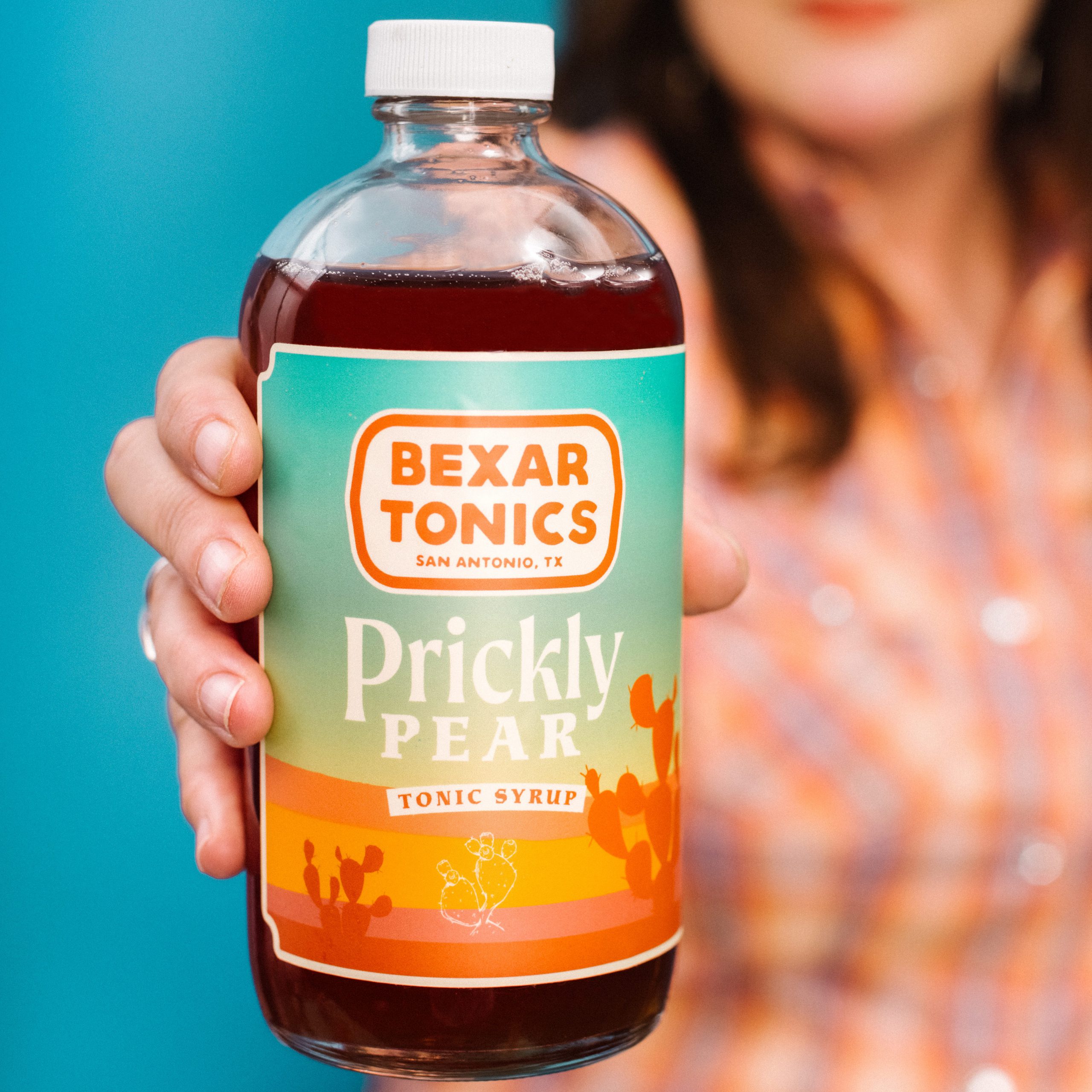 hand holding bottle of prickly pear tonic